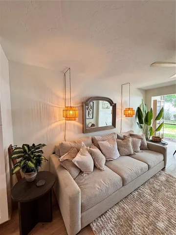 a living room with furniture and a lamp