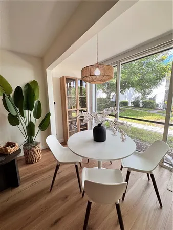 a view of a dining room with furniture window and wooden floor