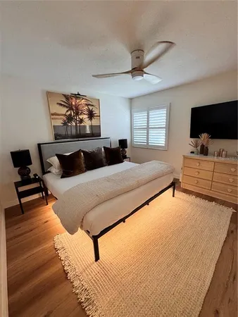 a bedroom with a bed and flat screen tv