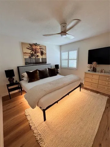 a bedroom with a bed and flat screen tv