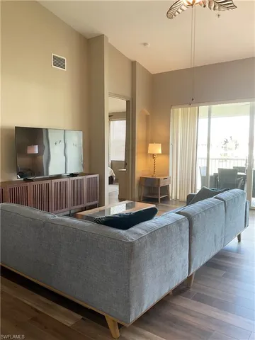 a living room with couches and a flat screen tv