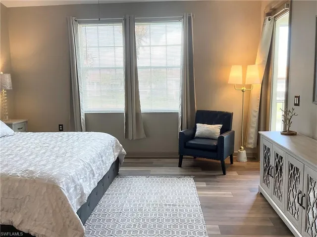 a bedroom with a bed and a large window