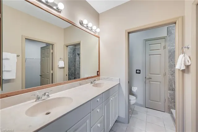 a spacious bathroom with a double vanity sink mirror and double