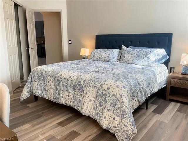 a bedroom with a bed and a night stand