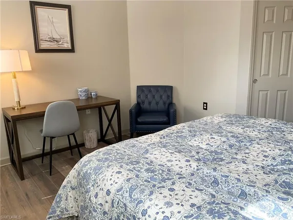 a bedroom with a bed and a table in it