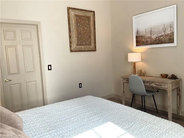 a bedroom with a bed and a table in it