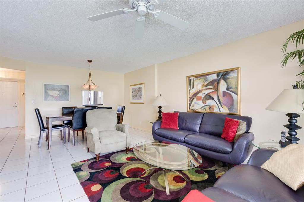 190 Southeast 5th Avenue, Unit 108 Dania Beach, FL 33004 - Photo 13 of 40 a living room with furniture and a dining table with rug