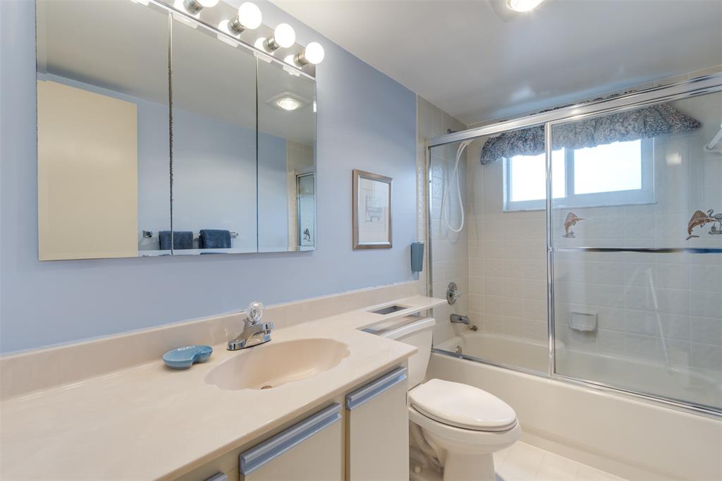 190 Southeast 5th Avenue, Unit 108 Dania Beach, FL 33004 - Photo 18 of 40 a bathroom with a sink a toilet and shower