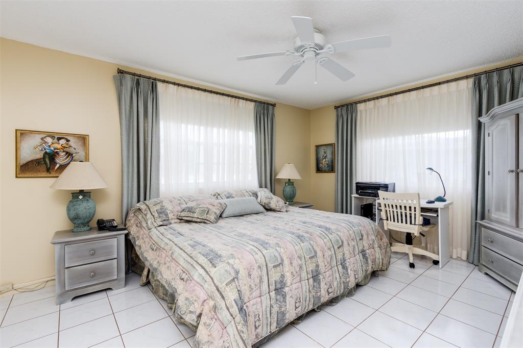 190 Southeast 5th Avenue, Unit 108 Dania Beach, FL 33004 - Photo 21 of 40 a bedroom with a bed and a chandelier