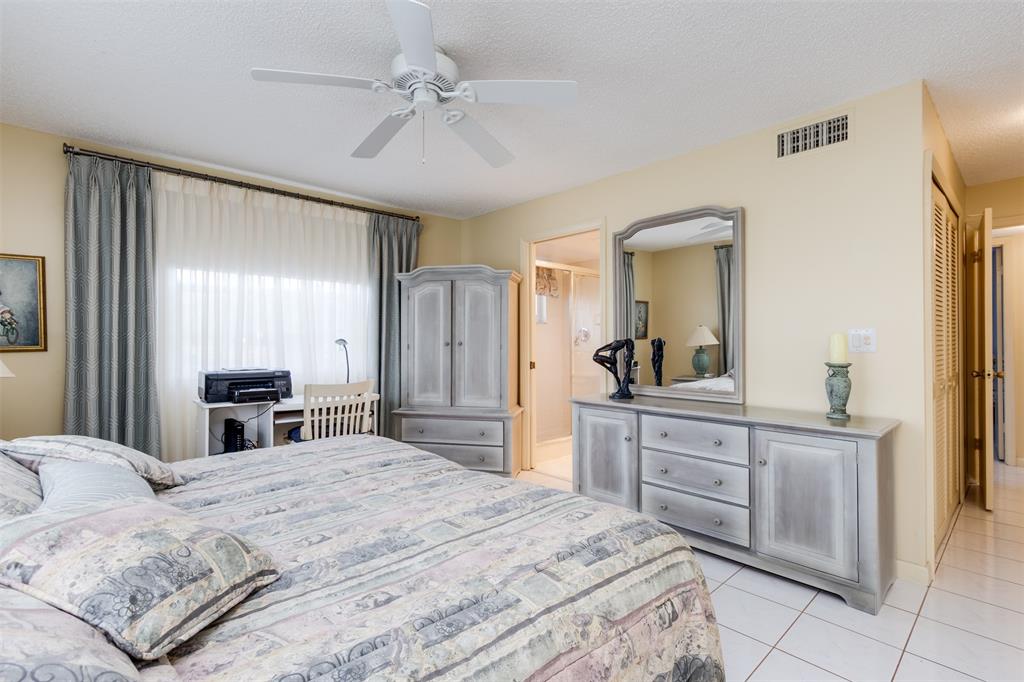 190 Southeast 5th Avenue, Unit 108 Dania Beach, FL 33004 - Photo 22 of 40 a large bedroom with a bed and a chandelier