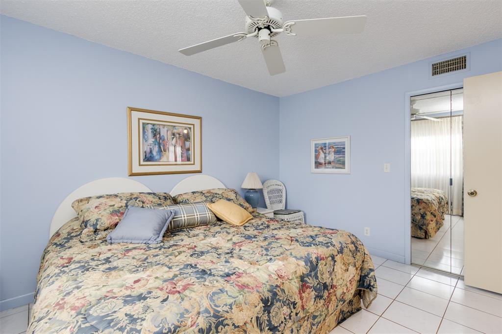 190 Southeast 5th Avenue, Unit 108 Dania Beach, FL 33004 - Photo 29 of 40 a bedroom with a bed and a painting on the wall