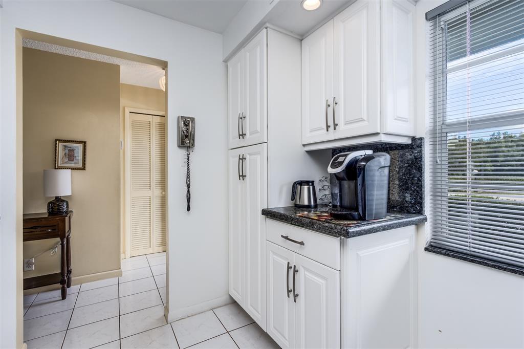 190 Southeast 5th Avenue, Unit 108 Dania Beach, FL 33004 - Photo 4 of 40 a kitchen with cabinets and a refrigerator