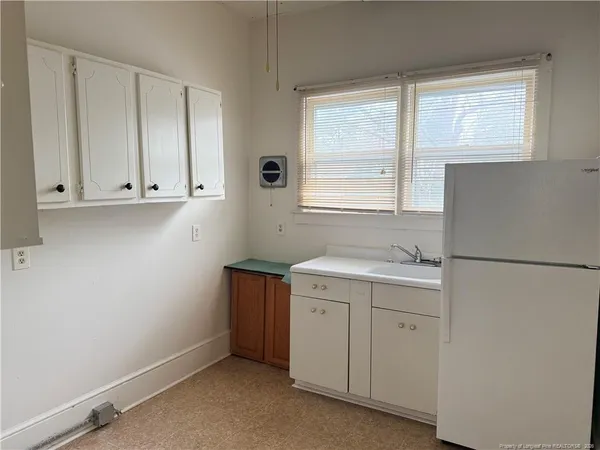 a kitchen with a sink cabinets and a window