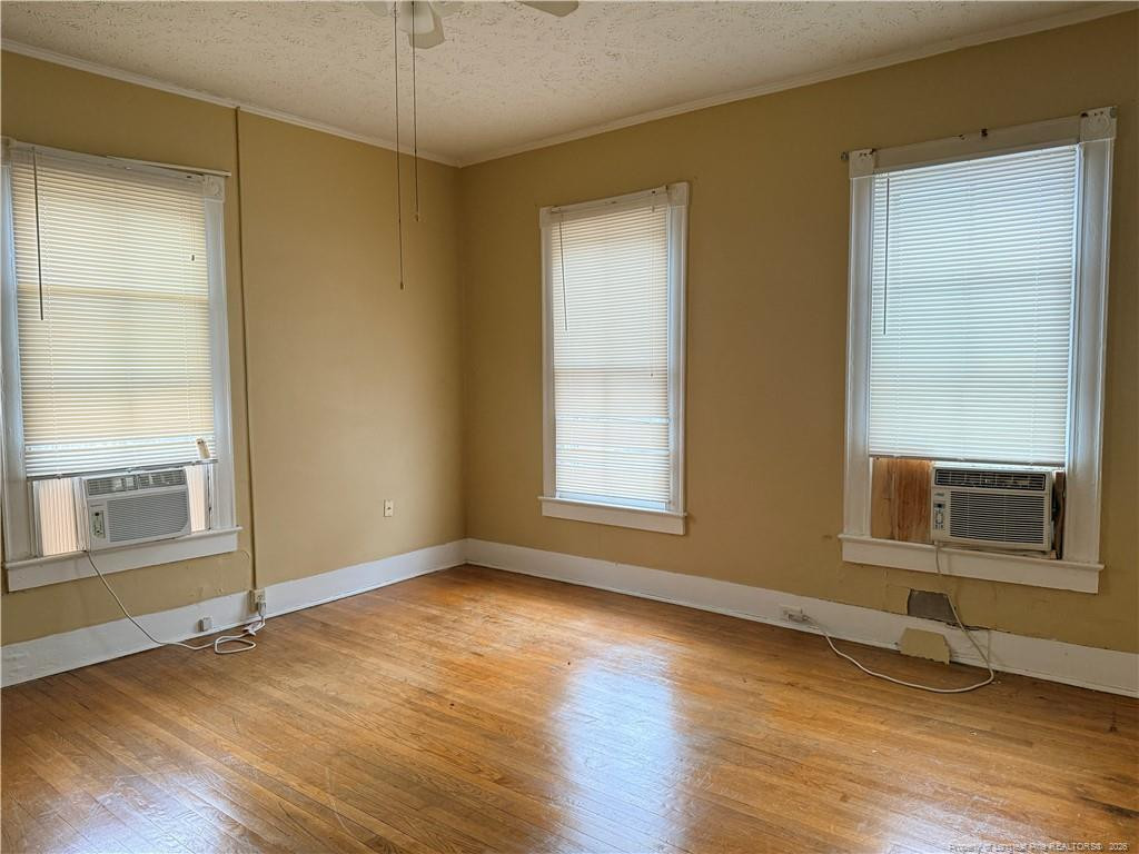 1201 Clark Street Fayetteville, NC 28305 - Photo 7 of 9 an empty room with wooden floor and windows