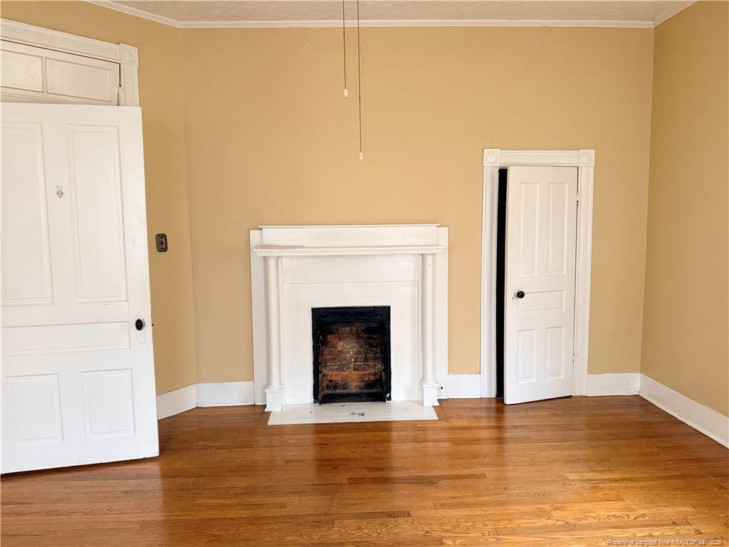 1201 Clark Street Fayetteville, NC 28305 - Photo 8 of 9 a view of a livingroom with wooden floor and a fireplace