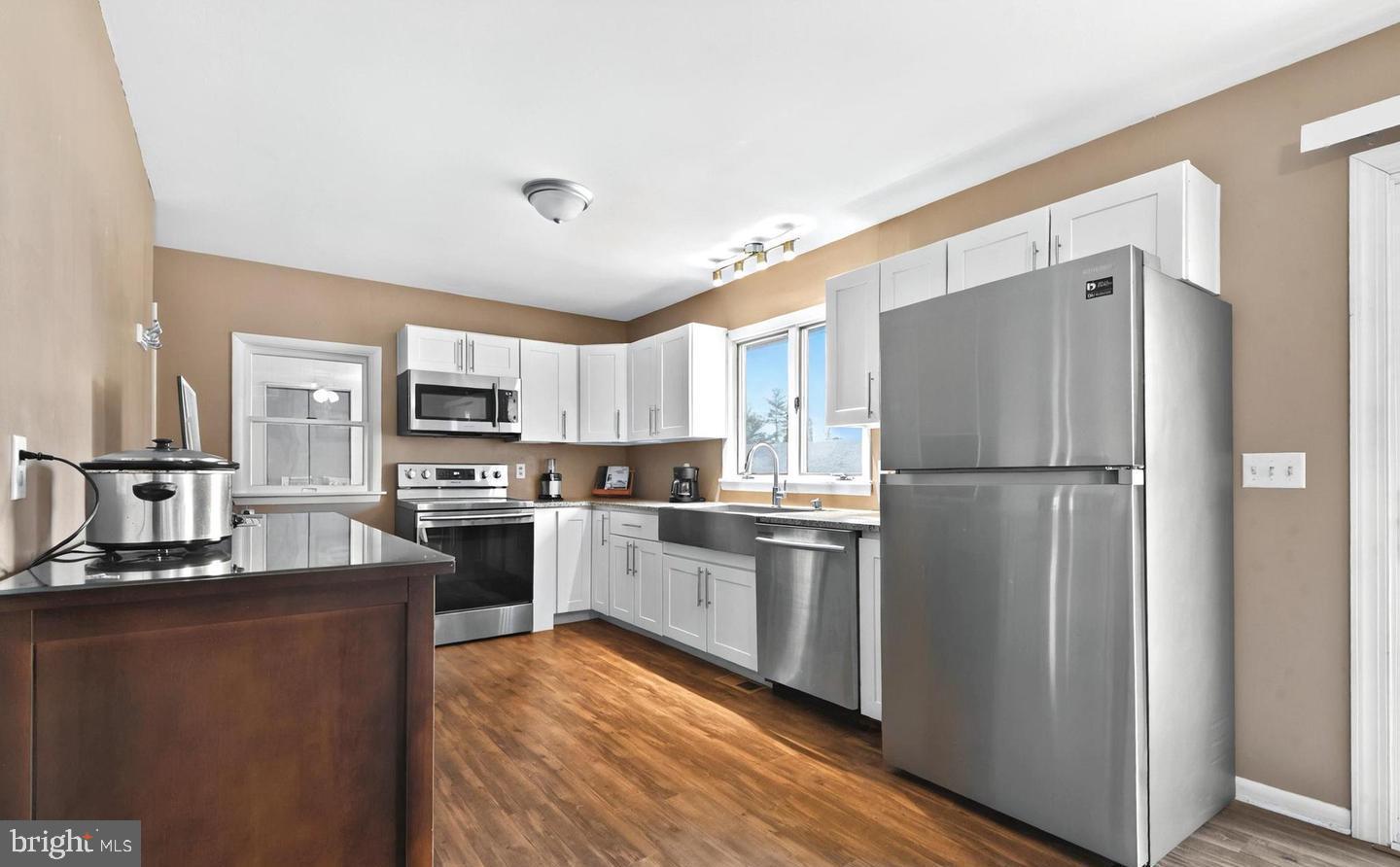 3240 Marston Road Westminster, MD 21157 - Photo 3 of 11 a kitchen with stainless steel appliances granite countertop a refrigerator a stove top oven a sink and dishwasher
