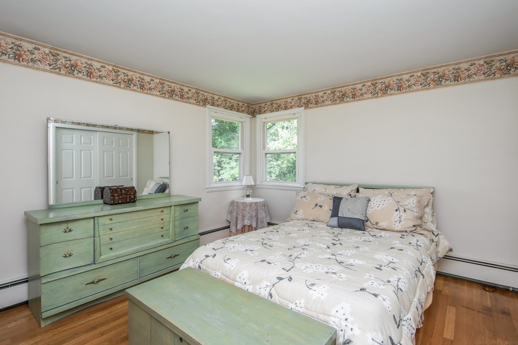 114 Arnold Road Sturbridge, MA 01518 - Photo 17 of 31 a bedroom with a large bed and a mirror on dresser