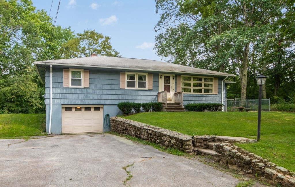 114 Arnold Road Sturbridge, MA 01518 - Photo 3 of 31 a front view of a house with a yard and garage