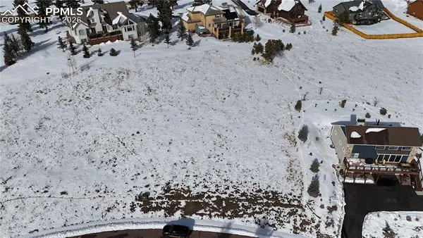 a view of water heater room with wooden floor