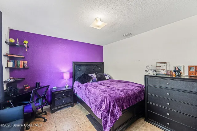 a bedroom with a bed and a closet