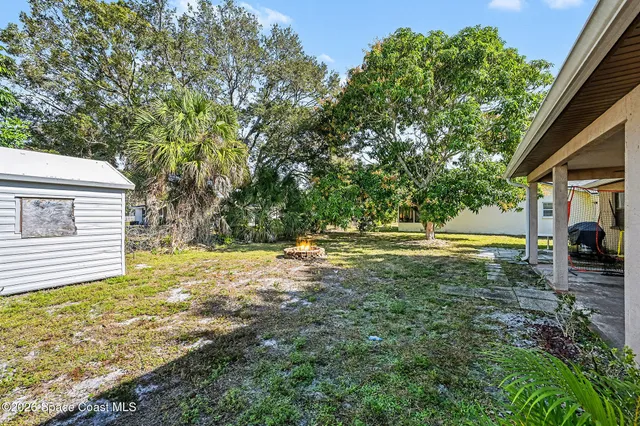 a view of a yard with swimming pool