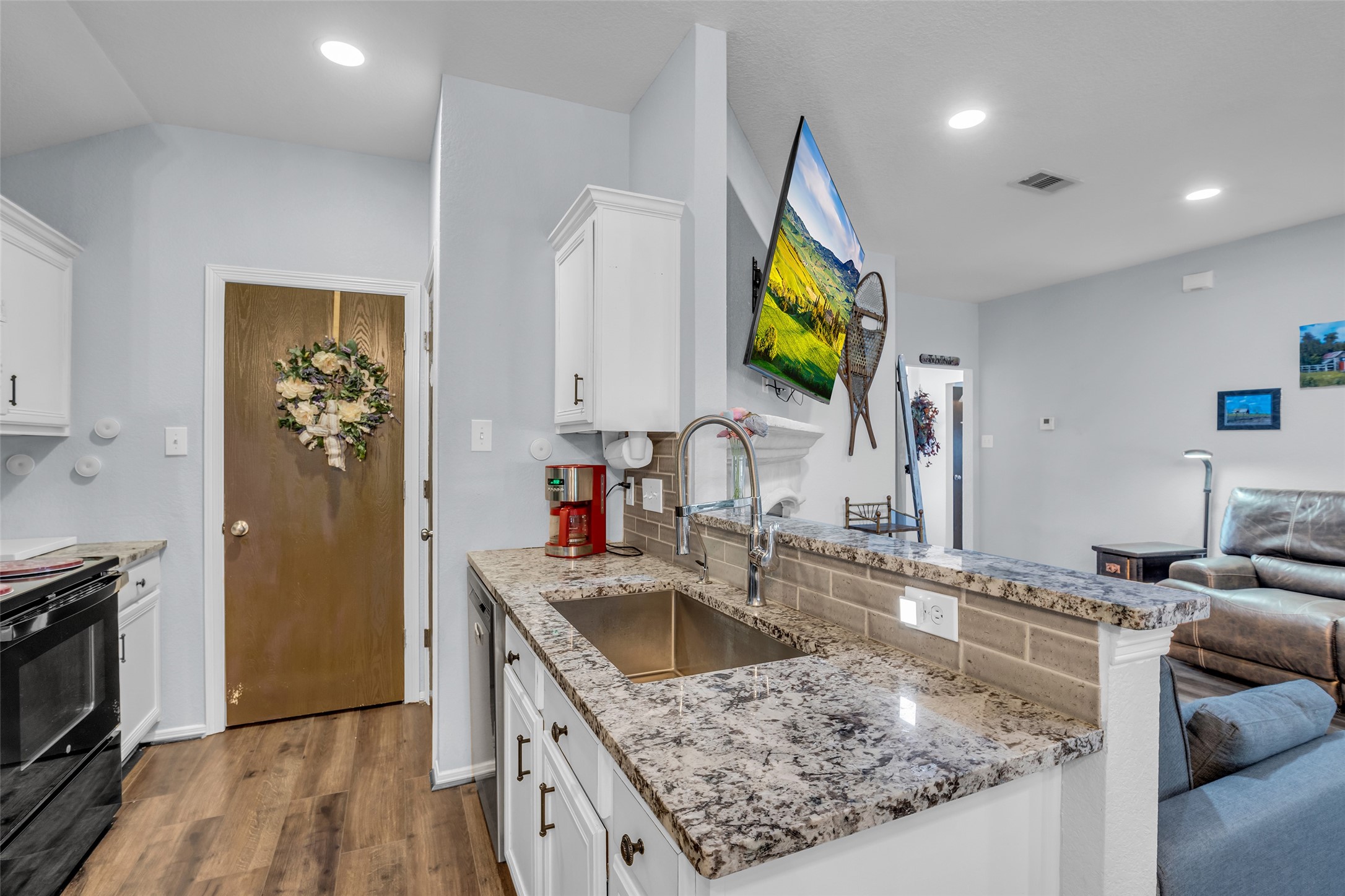 242 Sunset Path North Conroe, TX 77316 - Photo 23 of 37 Fridge transfers with sale. Your kitchen perch is command central, where you can see front door to the sunroom! 242 SUNSET PATH N - Request your tour today!
