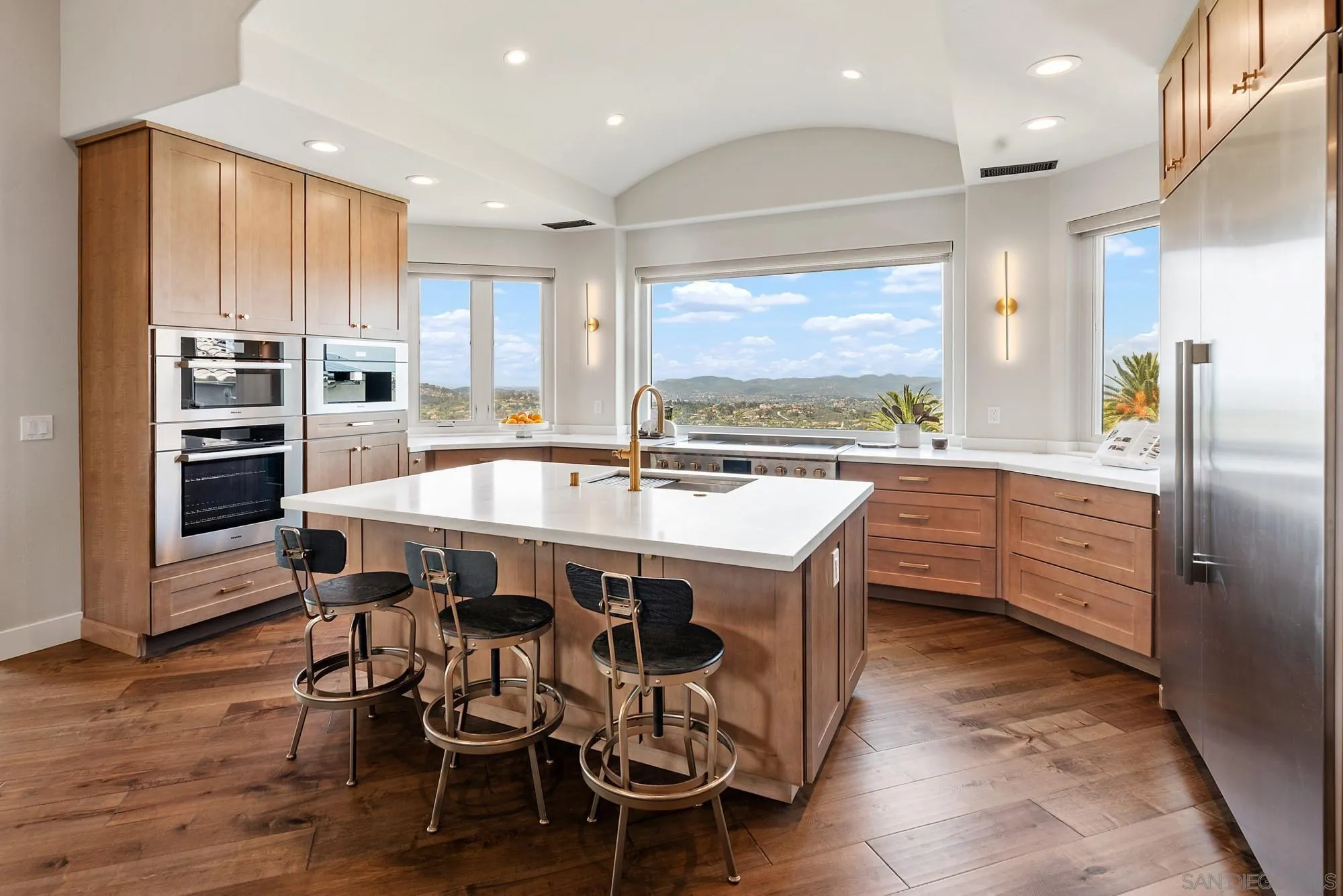 15484 Markar Road Poway, CA 92064 - Photo 12 of 75 a kitchen with stainless steel appliances kitchen island granite countertop a table chairs sink and cabinets