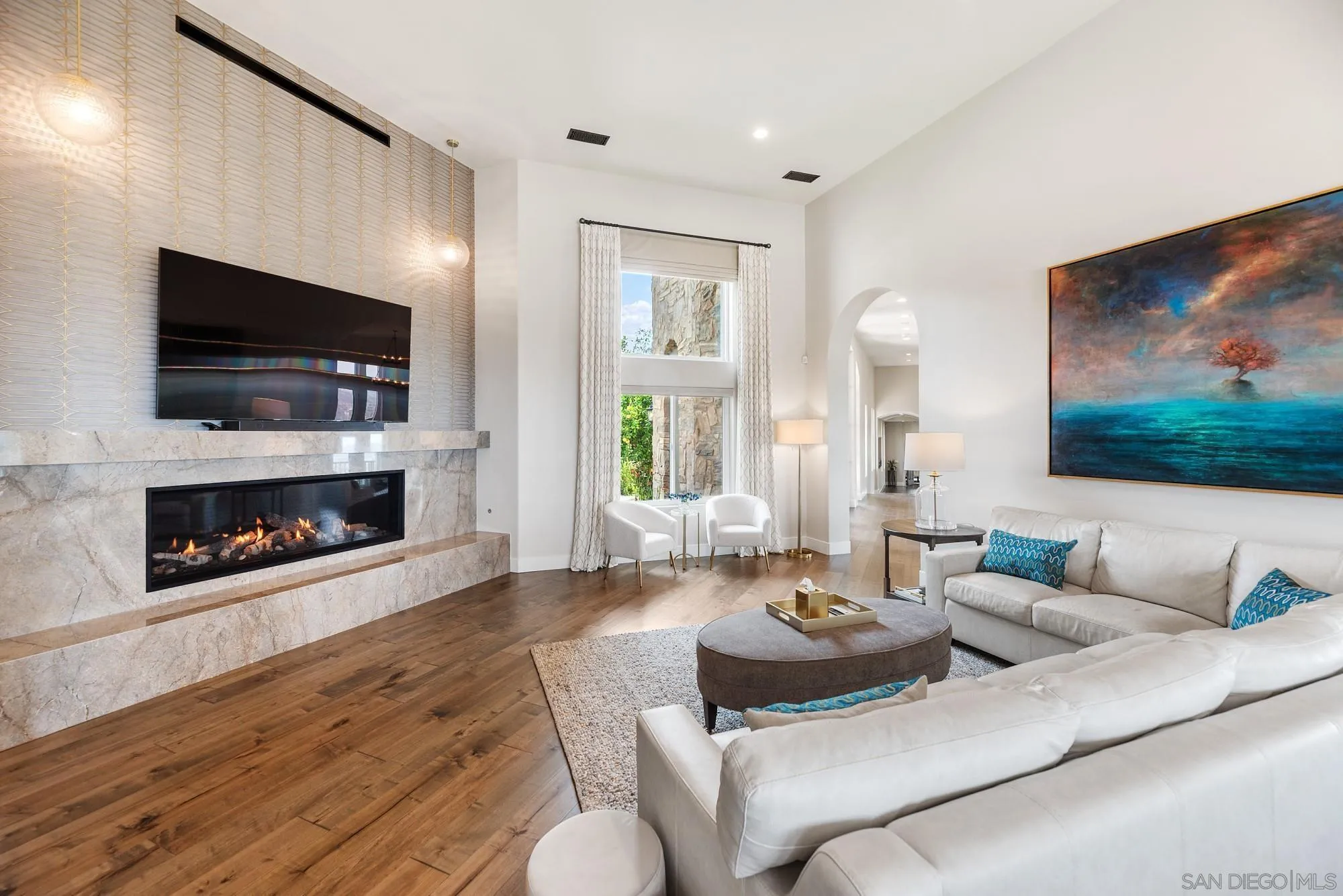 15484 Markar Road Poway, CA 92064 - Photo 19 of 75 a living room with furniture a flat screen tv and a fireplace