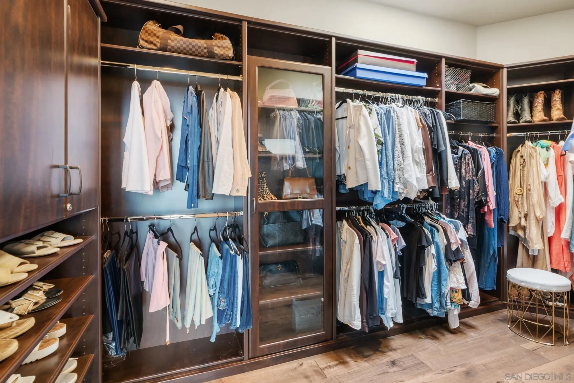 15484 Markar Road Poway, CA 92064 - Photo 35 of 75 a view of walk in closet with clothes and shoes