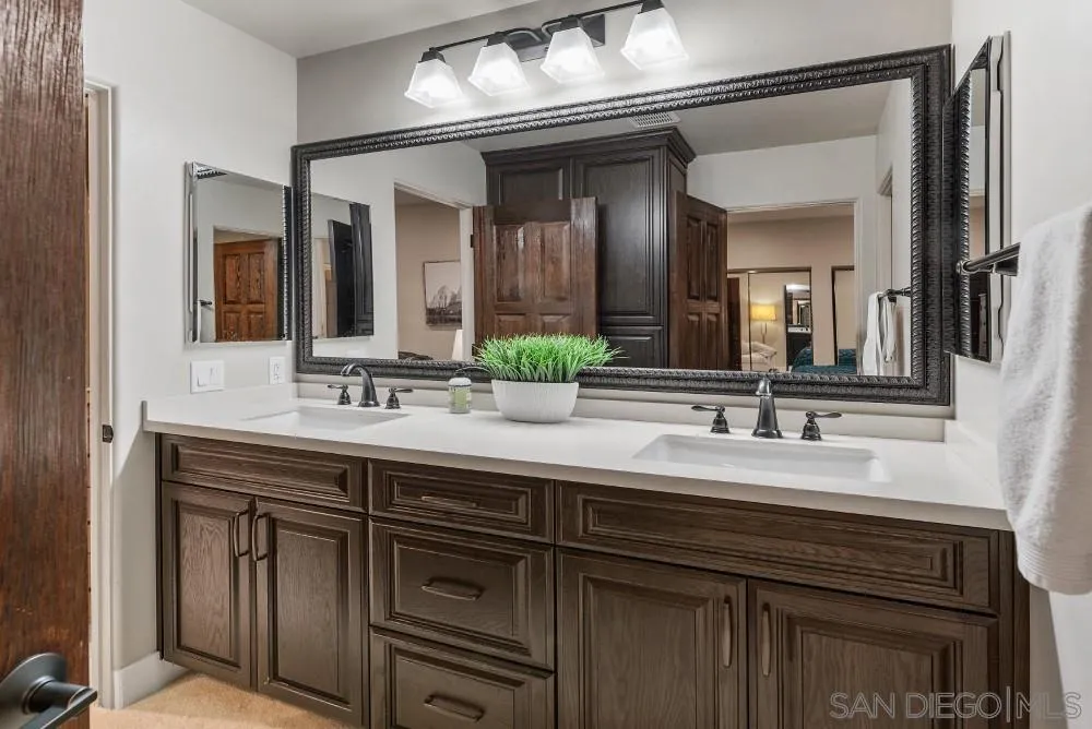 15484 Markar Road Poway, CA 92064 - Photo 38 of 75 a bathroom with a double vanity sink and a mirror