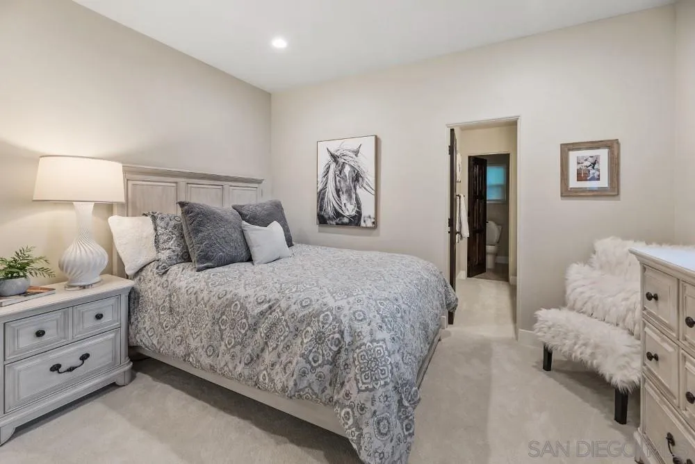 15484 Markar Road Poway, CA 92064 - Photo 40 of 75 a spacious bedroom with a bed and a lamp