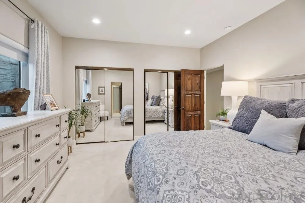 15484 Markar Road Poway, CA 92064 - Photo 41 of 75 a spacious bedroom with a large bed and wooden floor