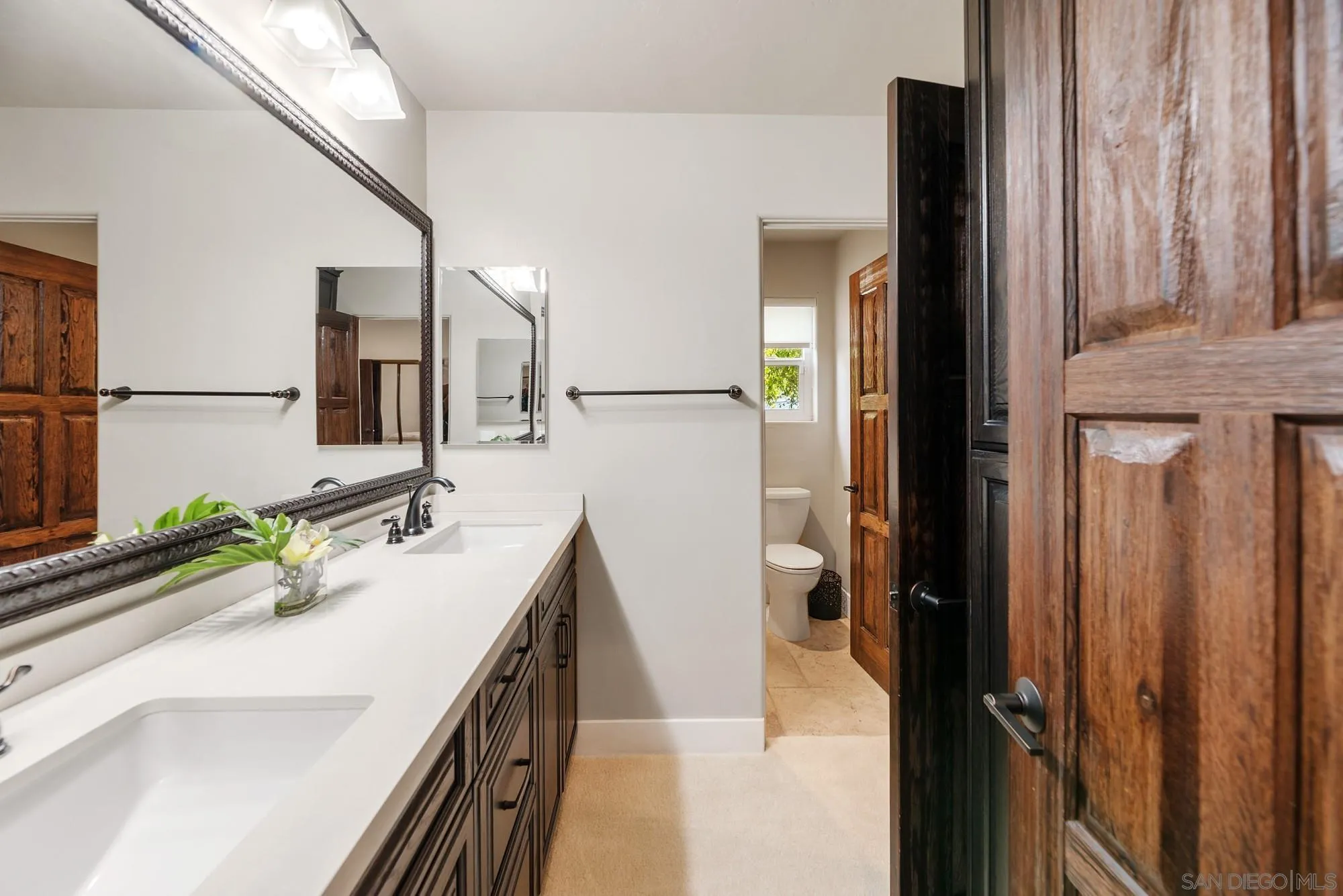 15484 Markar Road Poway, CA 92064 - Photo 46 of 75 a bathroom with a double vanity sink and mirror