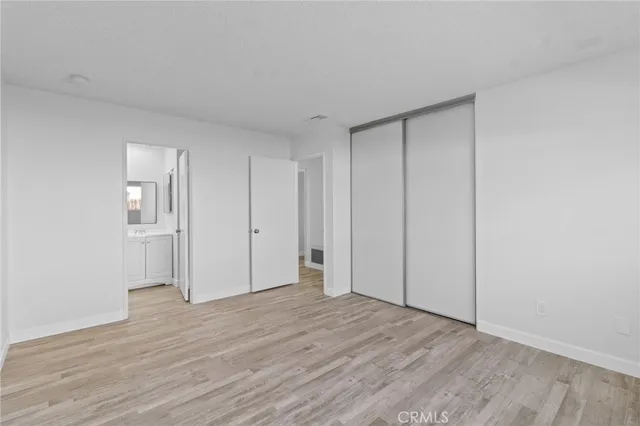 a view of an empty room and wooden floor