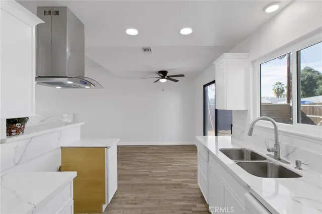 a kitchen with a sink a counter top space and cabinets
