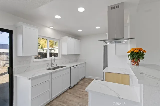 a kitchen with stainless steel appliances granite countertop a sink a counter space and cabinets