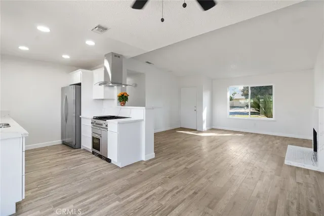 a kitchen with granite countertop a stove and a wooden floors