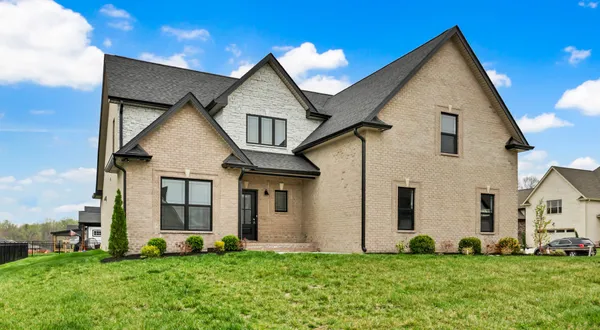 a front view of a house with a yard