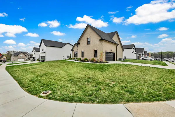a kitchen with stainless steel appliances granite countertop a sink a stove and a wooden floors