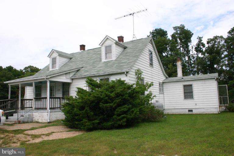 17648 Three Notch Road Dameron, MD 20628 - Photo 1 of 18 a front view of a house with garden