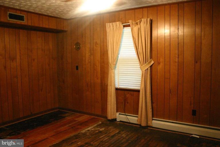 17648 Three Notch Road Dameron, MD 20628 - Photo 10 of 18 an empty room with wooden floor