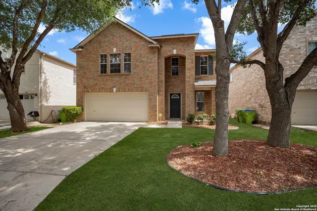 a front view of house with yard and green space