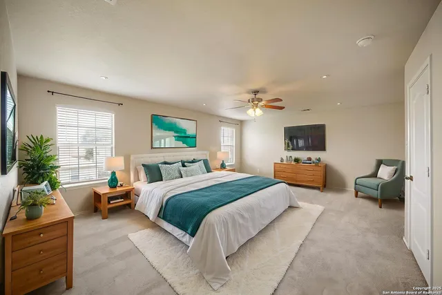 a large bedroom with a bed and a couch