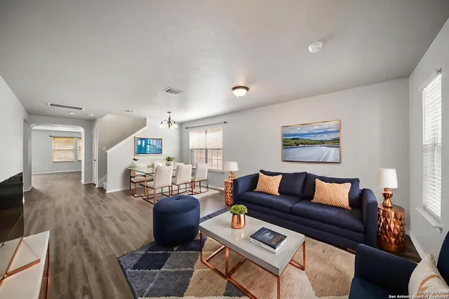 a living room with furniture and wooden floor