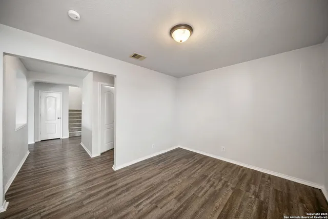 a view of a room with wooden floor