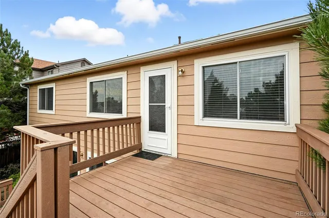 a view of a house with wooden deck