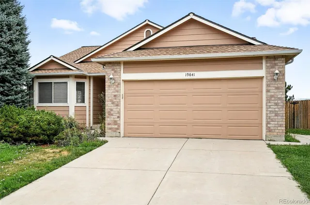 a front view of a house with garage