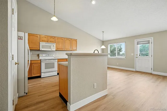 a kitchen with a stove a sink and a refrigerator