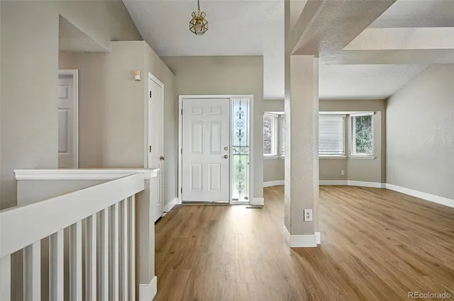 a view of hallway with wooden floor