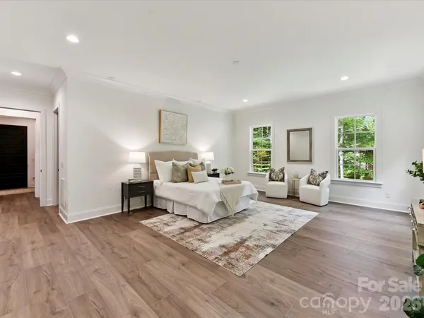 a bedroom with furniture and a large window